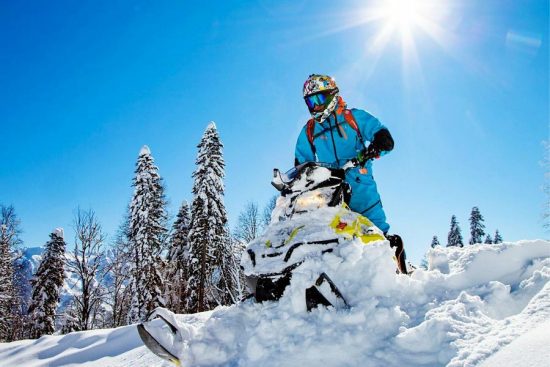 Snowmobiler riding through the scenic snowy trails of Saguenay, Quebec