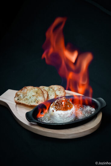 Flambéed cheese dish prepared by the chef at Tomahawk Grill.