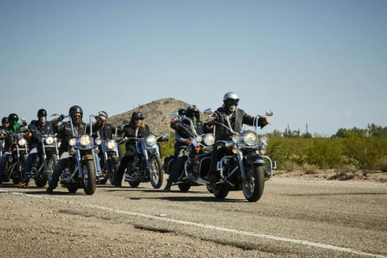Motorcyclists riding on a scenic road in Saguenay-Lac-Saint-Jean, Quebec.