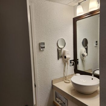 A clean and stylish bathroom featuring modern amenities at Hôtel La Saguenéenne.